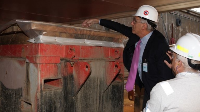 Matson President Ron Forest places ceremonial coins at the keel laying ceremony.