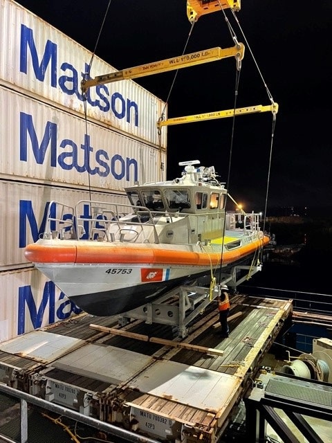 U.S. Coast Guard patrol boat prepare for transport aboard a Matson vessel
