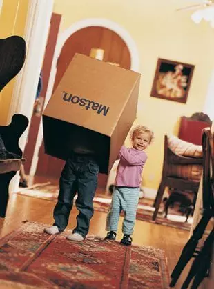 Children playing with Matson household shipping box.